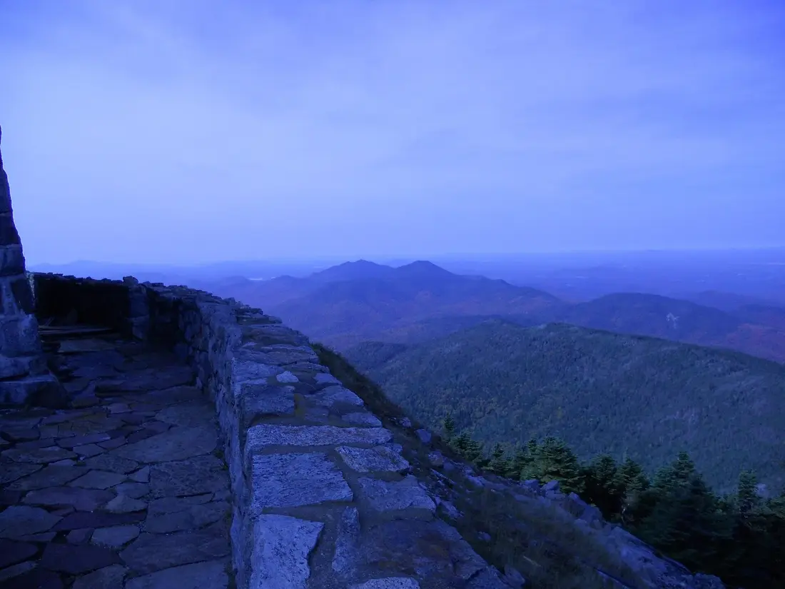 The stone wall at the Whiteface Mountain summit at dusk, looking over the Adirondacks