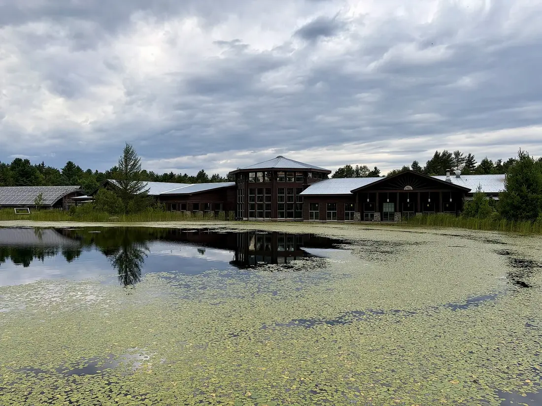 The Wild Center museum buildings across a pond in Tupper Lake, New York