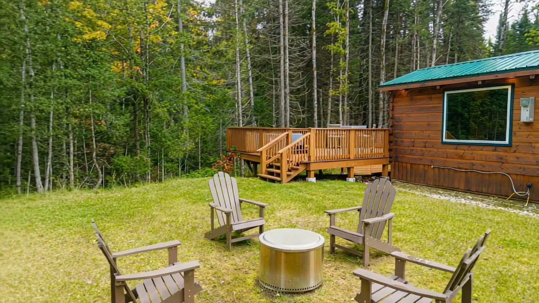 The Aviator's smokeless fire pit and four Adirondack chairs on its own lawn