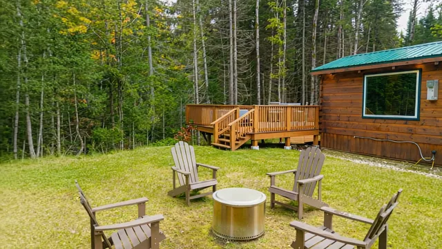 Adirondack chairs around the smokeless fire pit on The Aviator's lawn