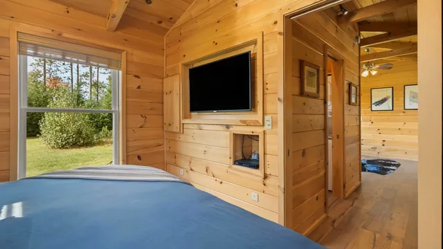 The Modern Tiny Home's main bedroom with a wall-mounted TV