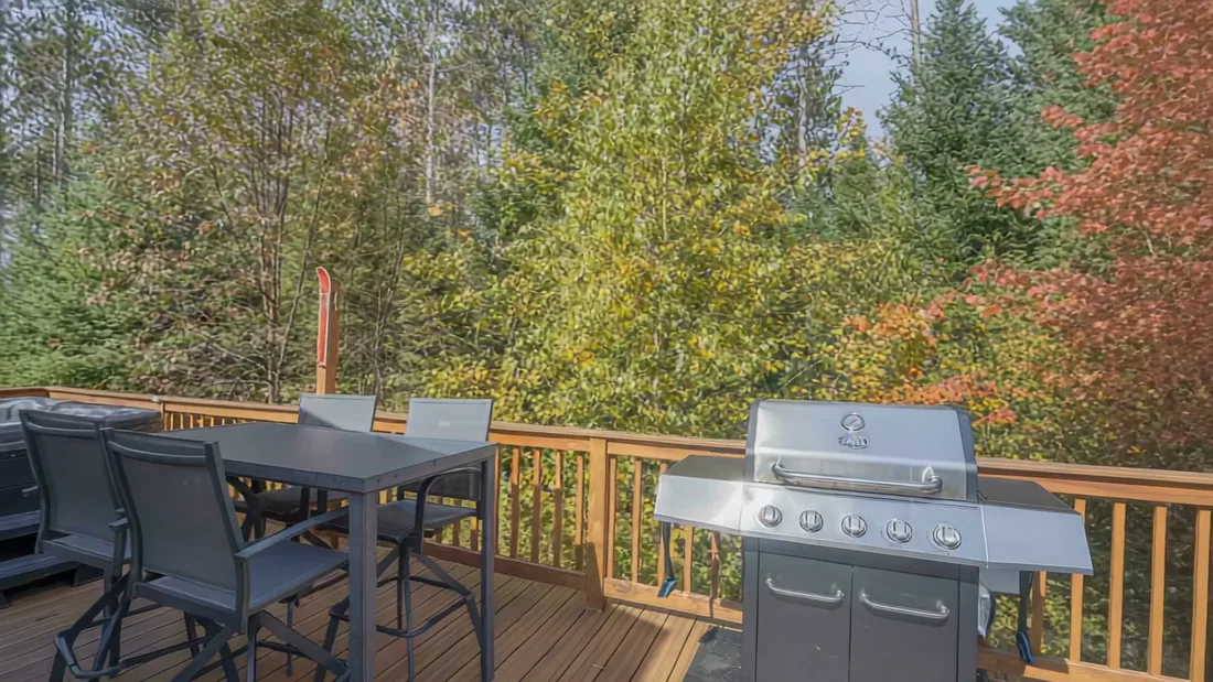 The Modern Tiny Home's deck with the grill and an outdoor table