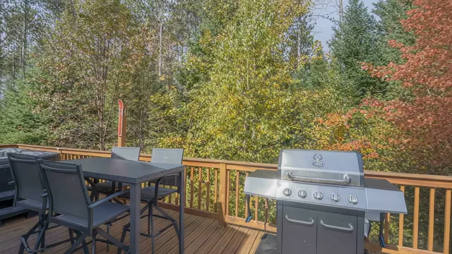 The Modern Tiny Home's deck with the grill and an outdoor table