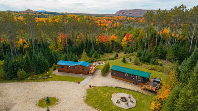 The Modern Tiny Home's property from above, with its neighboring cabin and the stone fire pit