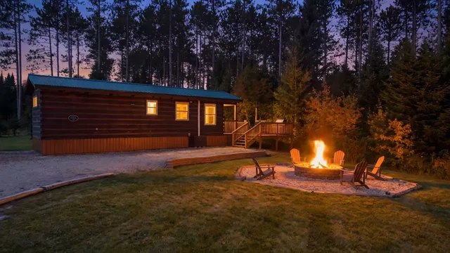 The stone fire pit lit at dusk at The Modern Tiny Home