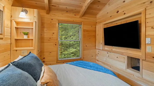 The Modern Pine's main bedroom with a wall-mounted TV